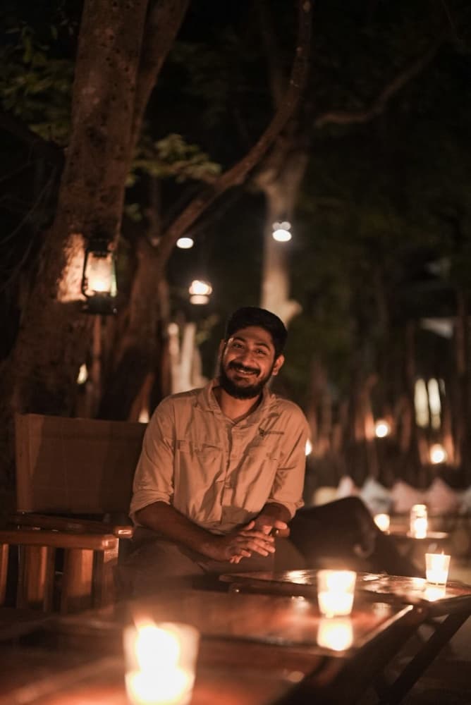 Portrait of a team member at the edge of a forest